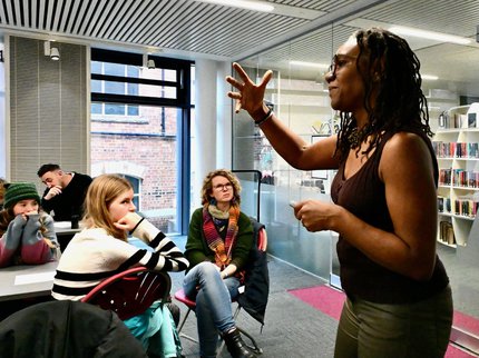 Presenter at front of a poetry workshop.