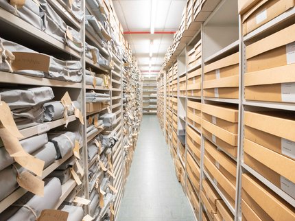 Inside the archives - looking down an isle of packages on shelves