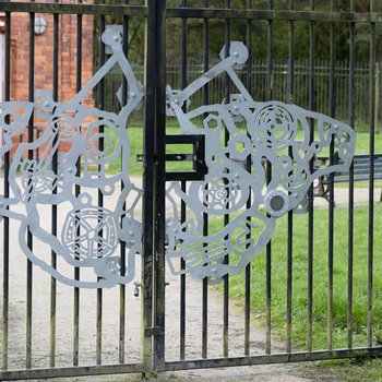 A metal casted butterfly on the gates at Bestwood Country Park