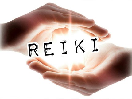 Hands cupped around the word Reiki