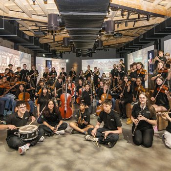 A group of musicians pose in a music room