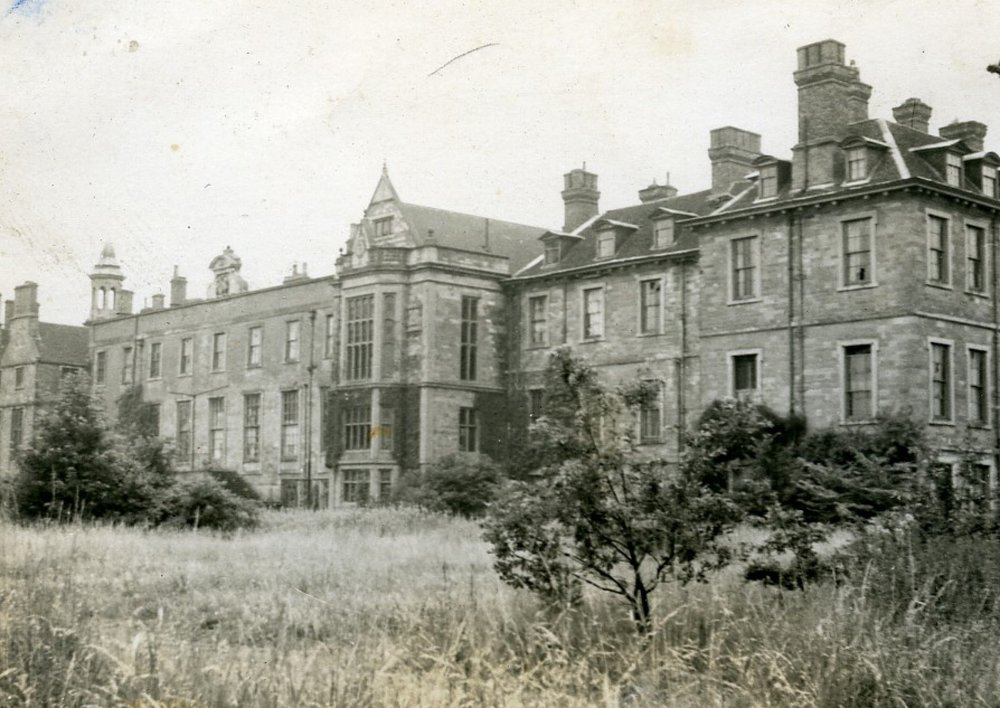 Black and white image of Rufford Abbey with grass and trees