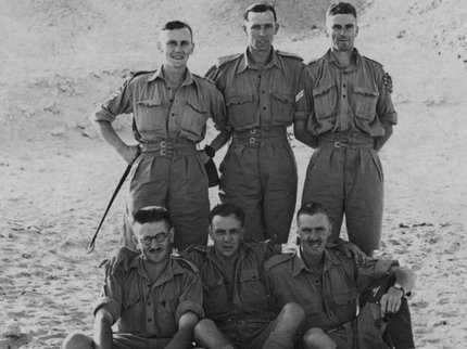 Six soldiers posing in front of pyramids in Egypt during WW2