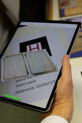 A tablet displaying a digital version of a historic record