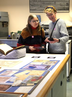 Two adults stood looking at augmented reality content on a device