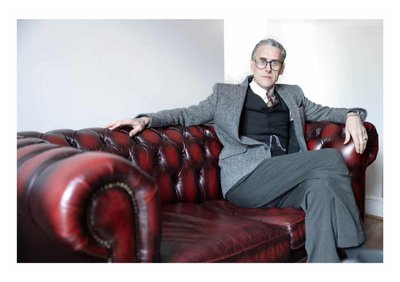 Andrew Graves sitting on a Chesterfield sofa wearing a three-piece suit