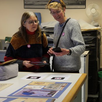 People viewing augmented reality content via smartphone in conservation studio