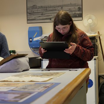 People viewing materials in conservation studio