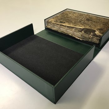 Inside new bespoke box showing old and damaged book