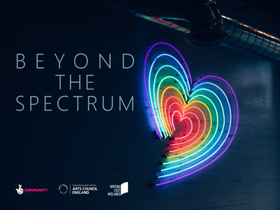 A neon rainbow heart, with the words Beyond the Spectrum next to it