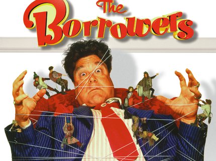 Film poster cover for the Borrowers - a man in a suit is sat in a red chair and tied up with strings held by tiny people