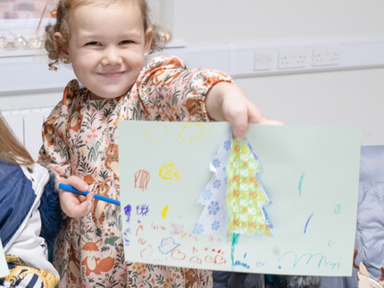 Children smiling at christmas craft activity