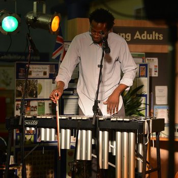 Photo of Corey Mwamba playing the vibraphone