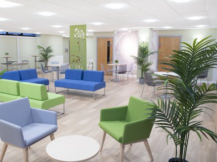 Mansfield cafe area with seating and tables in blue and green.