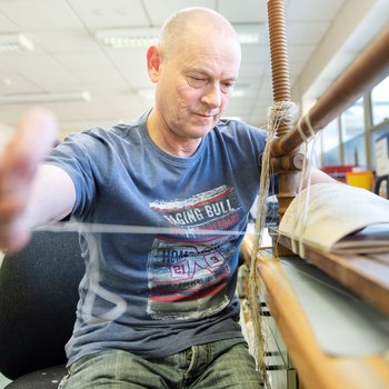 Conservator replacing the binding on a book