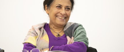 A smiling woman sat at a desk