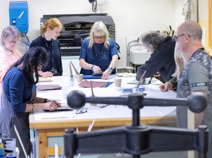 A group taking part in a book binding workshop at Nottinghamshire Archives