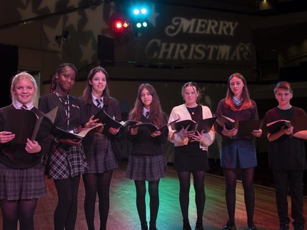 picture of a groups of singers on stage for christmas