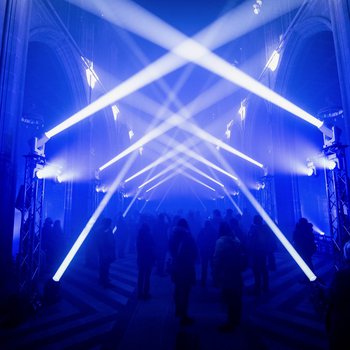 Crowd of people in a dark church with blue lighting