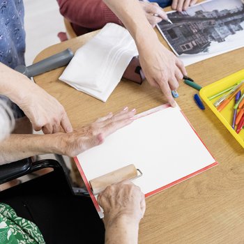 Photograph showing two people using a print roller