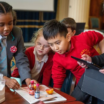 A group of primary school pupils conduct an experiment.