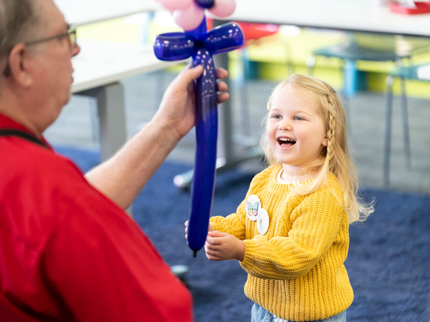 Child smiling with balloon animal