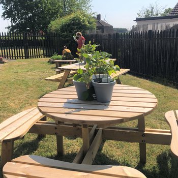 outdoors with a picnic table centre