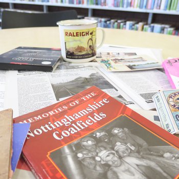 Memory lane bag display with books and other resources on a table