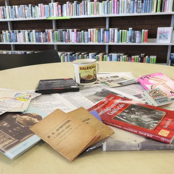 Memory lane bag display with books and other resources on a table