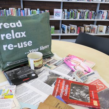 Memory lane bag display with books and other resources on a table