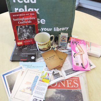 Memory lane bag display with books and other resources on a table