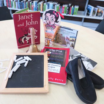 Memory lane bag display with books and other resources on a table