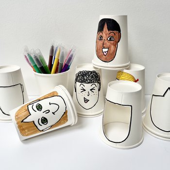 Photo of paper cups, decorated with faces