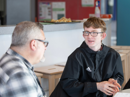 Student chatting to teacher