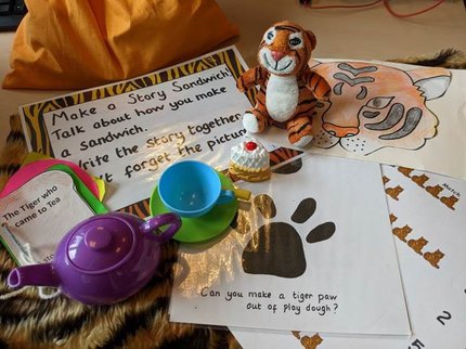 A toy tiger with cup, saucer and teapot