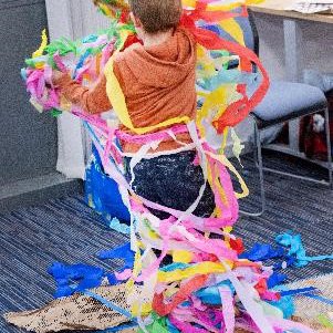 Child playing in multi-coloured streamers