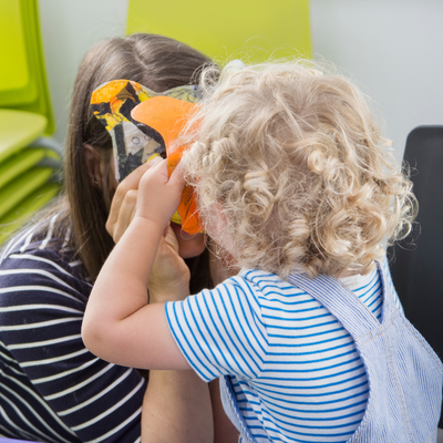 Grown-up and child are crafting together.