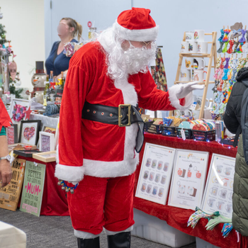 Santa and his Elf browsing at the Christmas market