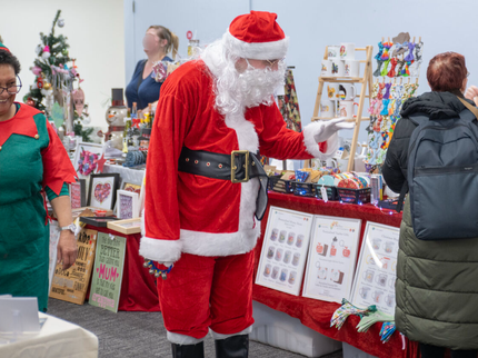 Santa and his Elf browsing at the Christmas market