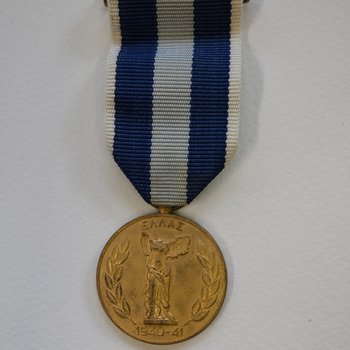 A medal on a blue ribbon before