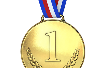 A first, gold medal with a red, white and blue ribbon attached at the top