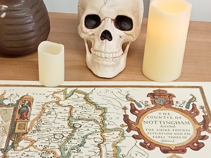 Map of Nottinghamshire with a skull and candles