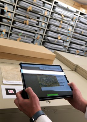 A tablet being pointed at a marker, showing a document on screen