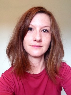 Photo of author Philippa East - a white woman with dark brown hair, wearing a dark red top.