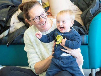 Parent and child singing together at a library session