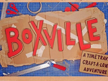 Boxville logo on carnboard, surround by scissors, tape and ruler