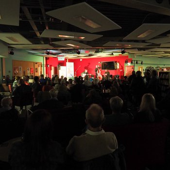 Photo of the Remi Harris Project on stage with an audience