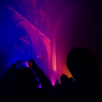 Interior of a church lit with pink and orange lights