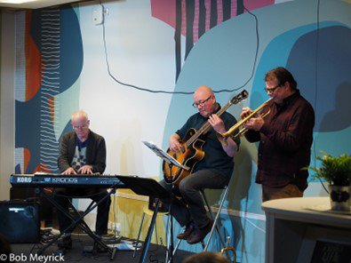 Group photo of the three members of Threeway playing keyboard, guitar and trumpet