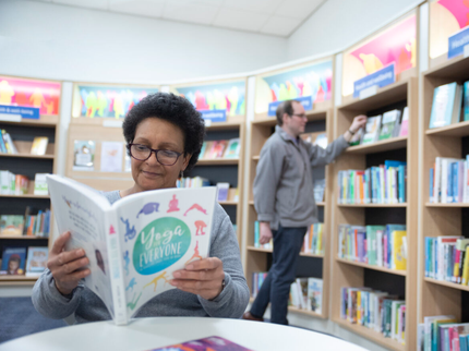 Lady reading a health and wellbeing book in a library